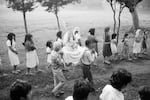 An altar with a statue of Jesus Christ is carried in a religious procession through the streets in Perquín, Morazán department, El Salvador, October 23, 1983.