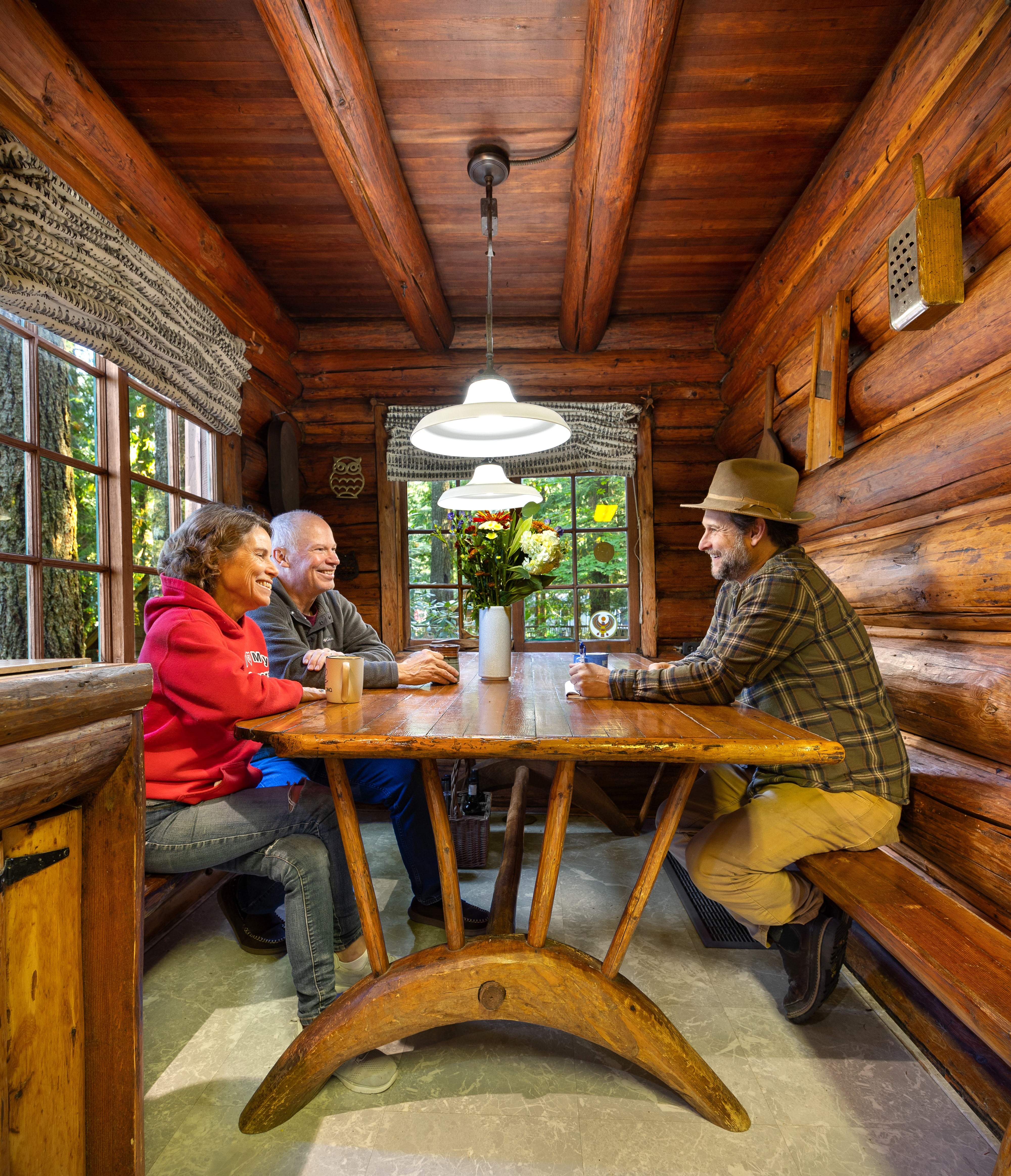 Author Ian McCluskey interviews the Doug and Laurie Dougherty in September 2024 in their family cabin, restored by Doug's mother, the late Nancy Dougherty. When Nancy moved into the cabin in the 1970s, the handmade dining table had been discarded in a snow bank. Today, the work of Henry Steiner is recognized for its historic and cultural significance.