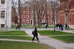 Pedestrians walk through Harvard Yard at Harvard University, Tuesday, April 15, in Cambridge, Mass.