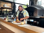 Chef Jonathan Biko Mandela Jones cooking during a preview night for BIRDFAT in Portland, Ore. on July 16, 2026. The pop-up was co-created with winemaker Tiquette Bramlett of Henderson Ave.