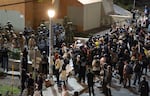 Masked-up federal agents confront the protesters in the driveway of the Immigration and Customs Enforcement facility in Portland, Ore., on Sept. 28, 2025.