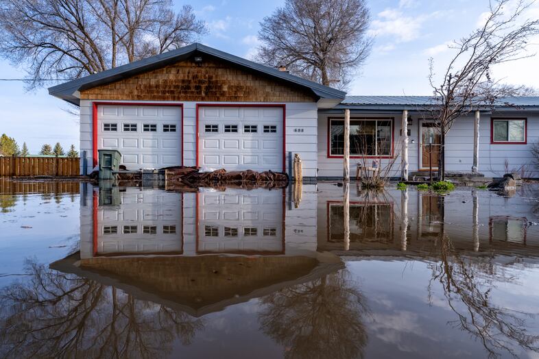 Sandbags, tarps and other items are used to try and prevent flood damage at this home in an evacuated area in Burns, Ore., March 30, 2025.