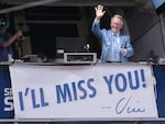 Los Angeles Dodgers broadcaster Vin Scully waves to the crowd after leading in the singing of Take Me Out to the Ball Game against the Colorado Rockies in 2016, his final season.
