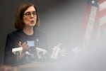 Gov. Kate Brown speaks at a press conference on March 16. Brown announced she is closing the state’s bars and restaurants and banning gatherings of more than 25 people.