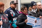 Eric Martin, left, and his mother, center, attend a rally for Paulino Martin in Beaverton, Ore., on Friday, Nov. 28, 2025. Martin, a resident of Beaverton for over 30 years, was arrested by Immigration and Customs Enforcement on Nov. 18. 