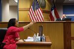 Fulton County District Attorney Fani Willis speaks from a witness stand in front of Fulton Superior Judge Scott McAfee during a Feb. 15 hearing about whether Willis' office should be disqualified from the Georgia election interference case.