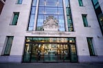 This photo shows the outside of Westminster Magistrates' Court in London. It's a multistory building with glass doors.