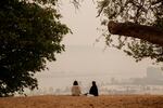 A lone couple takes in a smokey view at the Skidmore Bluffs, a usually packed overlook popular with picnickers taking in the sunset. Due to smoke blowing in from several surrounding wildfires, the air quality in Portland, OR been ranked the worst of all major cities in the world. Sept. 10, 2020.