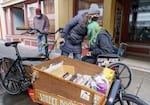 Diana Rempe, left, hugs Jennifer Bradford, right, during a Street Books shift. Bradford was looking specifically for coloring books.