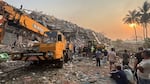 Rescuers work with the help of heavy machinery at the Sky Villa Condo that collapsed In Friday's earthquake in Mandalay, Myanmar on Sunday.