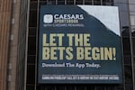 A Caesars Sportsbook gambling advertisement on the exterior of a building in New York City in 2024.