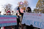 Supporters of transgender rights hold signs saying "Medical care is a human right" and "The Constitution protects trans kids" as they rally outside the Supreme Court on Wednesday in Washington, D.C.