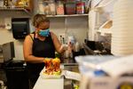 Gabriela Mendoza prepares a customer's lunch at Frutas Locas. The business is one of many in Vancouver's international district struggling in the pandemic.