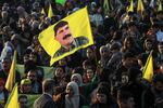 A woman waves a flag bearing a picture of the founder of the Kurdistan Workers' Party (PKK) Abdullah Ocalan, as people gather in the Kurdish-majority city of Qamishli in northeastern Syria to listen to a message from the jailed leader on Feb. 27.