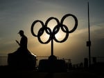 The sun sets behind the Olympic rings at the Olympic marina during the 2024 Summer Olympics, Friday, in Marseille, France. 