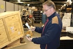 Dan Rolince, U.S. Fish and Wildlife Service Office of Law Enforcement supervisor, inspects a bottle of snake wine. It’s one of the 1.5 million pieces of wildlife trafficking evidence in the National Eagle and Wildlife Property Repository.
