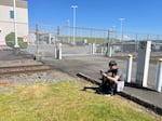One of Ky Sengdara's sons waits outside a gate at the Northwest ICE Processing Center in Tacoma on May 4.