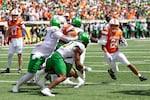 Oklahoma State running back Caleb Hawkins (24) runs the ball in the first half of the NCAA college football game against Oregon in Stillwater, Okla., Saturday, Sept. 12, 2026.