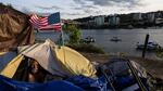 A man named Frank sits in his tent with a river view in Portland, Ore., in 2021. A lawsuit originally filed in 2018 on behalf of homeless people in the Oregon city of Grants Pass is set to go before the U.S. Supreme Court in April.