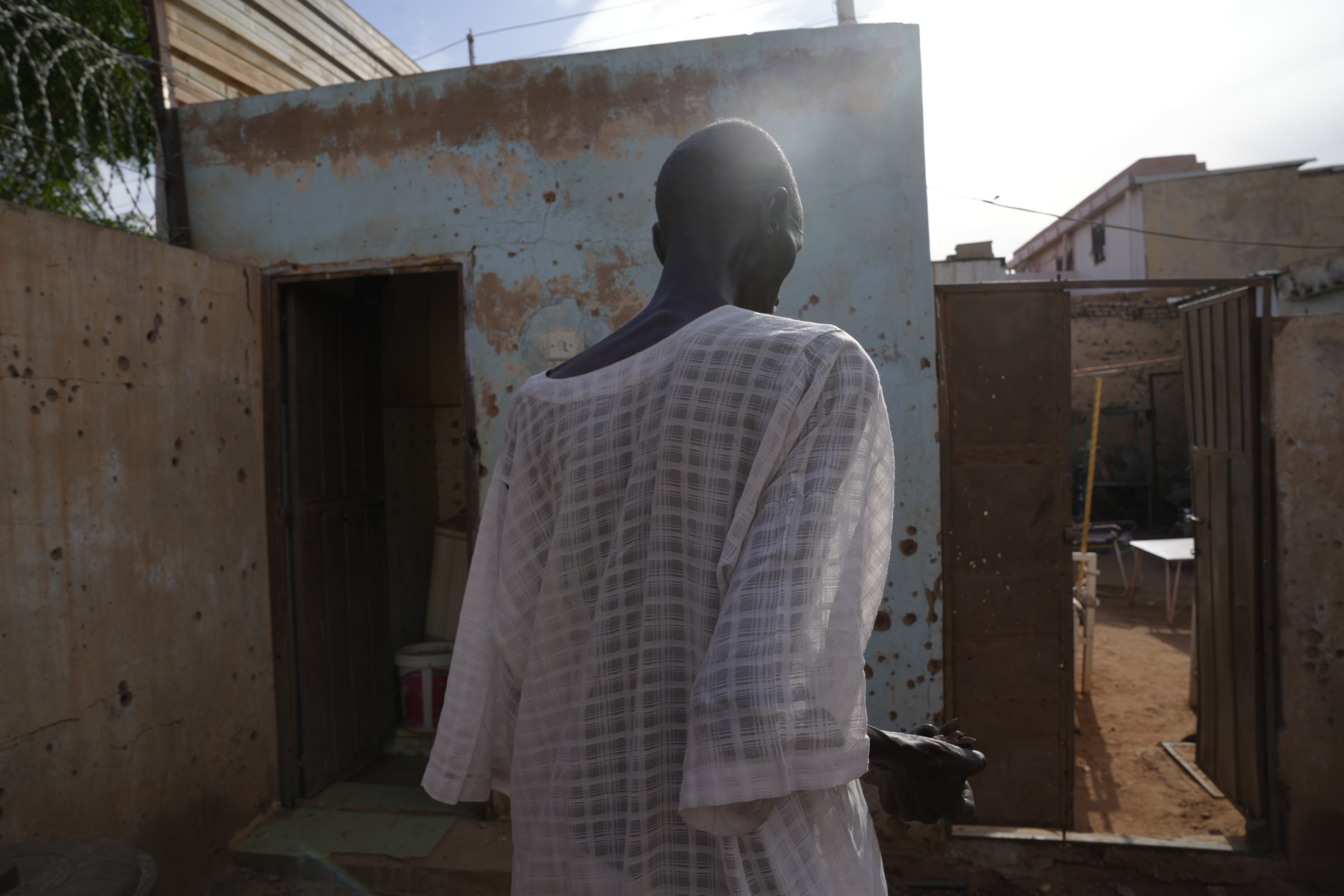 Ahmed Uduma says that bullets and shrapnel pierced his modestly sized brick bungalow — but he and the house survived.