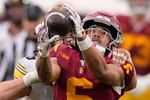 Southern California wide receiver Makai Lemon, right, makes a catch while under pressure from Iowa defensive back Zach Lutmer during the second half of an NCAA college football game, Saturday, Nov. 15, 2025, in Los Angeles.