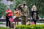 U.S. Army Sgt. Edwin Morales, center right, salutes after placing flowers for fallen FDNY firefighter Ruben D. Correa at the National September 11 Memorial and Museum, Friday, Sept. 11, 2020, in New York. The names of nearly 3,000 victims of the Sept. 11, 2001 terror attacks will be read by family members at a ceremony organized by the Tunnel to Towers Foundation.