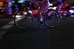 Nude riders cruise down the streets of Southeast Portland illuminated by police car lights at every major intersection.