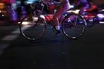 Nude riders cruise down the streets of Southeast Portland illuminated by police car lights at every major intersection.