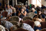 August 13: Survivors and churchgoers pray during a Sunday church service held by Pastor Brown of Lahaina's Grace Baptist Church, at Maui Coffee Attic in Wailuku, central Maui, Hawaii.