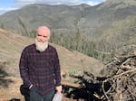 Applegate Siskiyou Alliance executive director Luke Ruediger standing in front of a clearcut at the Lickety Split timber sale on land managed by the BLM in the Little Applegate Valley in an undated photo.