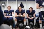 From left, Zach Mahan, Marshall McGuire and Garrett Roach listen to ther coach at halftime of the Oregon 6A football championship at Hillsboro Stadium in Hillsboro, Ore., Saturday, Dec. 7, 2019. Central Catholic defeated Lake Oswego 49-28.