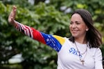 FILE - Opposition leader Maria Corina Machado waves from atop a truck during the closing election campaign rally for presidential candidate Edmundo Gonzalez in Caracas, Venezuela, Thursday, July 25, 2024. 