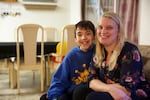 Class of 2025 student Raiden sits with his mother, Angela Williams, in their home in Vancouver in March 2018.