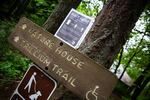 New signage instructs visitors to Tryon Creek State Park to maintain social distance while waiting for the park restroom in Portland, Ore., Wednesday, May 6, 2020.