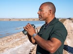 Christian Cooper watches distant shorebirds at the Sonny Bono Salton Sea National Wildlife Refuge in California. The National Geographic channel has announced that Cooper will host a series called Extraordinary Birder. Cooper was in the spotlight after a woman in New York City's Central Park called the police and falsely accused him of threatening her in May 2020.