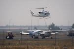A firefighting helicopter lands at Madras Municipal Airport in Madras, Ore., near the Bench Fire, on July 28, 2026.