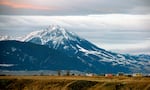 FILE: Emigrant Peak towers over the Paradise Valley in Montana north of Yellowstone National Park, on Nov. 21, 2016. Attorneys for a group of youths suing Montana over damages caused by climate change say officials repealed the state's energy policy to avoid an upcoming trial.