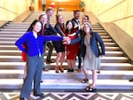A group of first-term lawmakers poses for a photo on the steps leading to Oregon's House of Representatives. From left: Rep. Khanh Pham, Rep. Maxine Dexter, Rep. Jason Kropf, Rep. Dacia Grayber, Rep. Wlnsvey Campos, Rep. Ricki Ruiz, Rep. Andrea Valderrama, Rep. Lisa Reynolds.