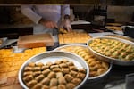 Different types of baklava are on display and being packaged at Gulluoglu, a shop in Gaziantep, Turkey. Shops across the city are adorned in green and gold — green for pistachios, gold for the dessert's flakey crust.