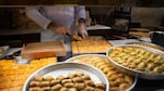 Different types of baklava are on display and being packaged at Gulluoglu, a shop in Gaziantep, Turkey. Shops across the city are adorned in green and gold — green for pistachios, gold for the dessert's flakey crust.