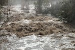 Marble Fork of the Kaweah River in the foothills of Sequoia National Park on Jan. 9. The river's high flow follows large amounts of precipitation, and the dark muddy color is partly due to debris from slopes burned in the 2021 KNP Complex Fire.