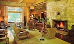 An old photo of the central lounge of the Oregon Caves Chateau, featuring the Monterey Style furniture