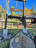 A wooden sign near the entrance of town.