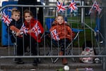 Children gather along the streets as they wait to view the cortege carrying the coffin of the late Queen Elizabeth II in Ballater, United Kingdom.