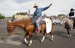 FILE - This Sept. 17, 2010, file photo shows Democratic gubernatorial candidate former Gov. John Kitzhaber riding a horse in the Westward Ho! parade during the Pendleton Round-Up, in Pendleton, Ore.