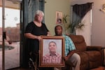 Bobbie (left) and DeForrest Williams hold a portrait of their son, Christian Williams, at their home in Buckeye, Ariz. Christian died at age 15 of diabetes complications while in a residential foster care program.