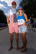 James Lewis, left, and Ashley Smith, of Richmond, Va., arriving to the race in red white and blue style.