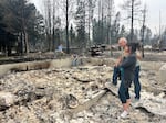 Mike and Stephanie Zappone comfort each other recently amid the ashes of their home in Medical Lake.
