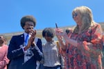 Justin J. Pearson stands with state Rep. Gloria Johnson during a rally in Memphis, Tenn., before a vote to reinstate him to the Tennessee House on April 12, 2023.