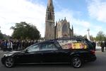 Members of the public line the streets in Ballater, Scotland, as the hearse carrying the coffin of Queen Elizabeth II passes through as it makes its journey to Edinburgh from Balmoral.